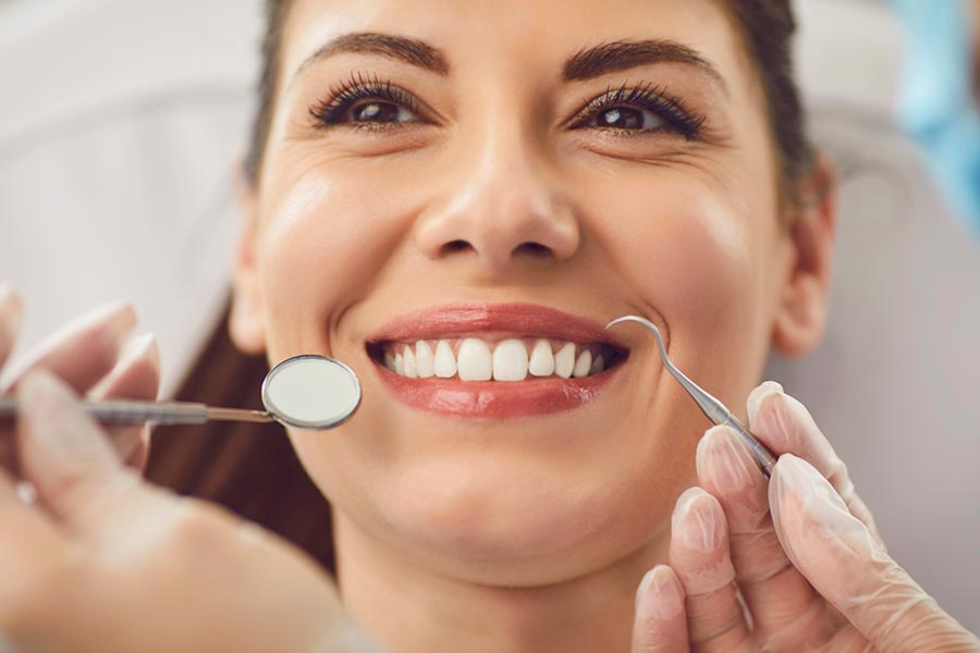Woman at the dentist with dental insurance in Battle Creek, MI